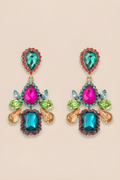 Colorful gemstone earrings on a beige background