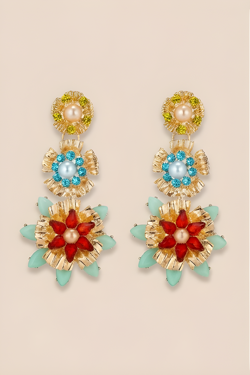 Colorful floral earrings with gold accents on a beige background