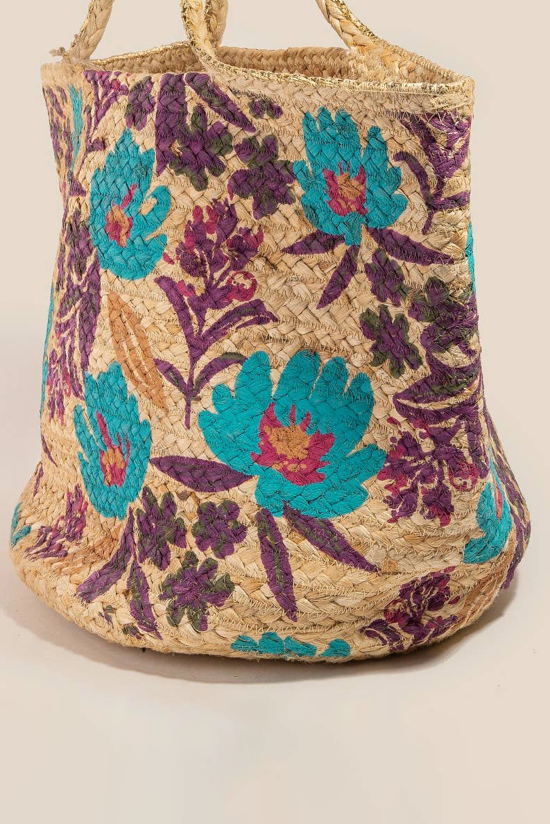 Woven bag with floral patterns in blue and purple on a beige background
