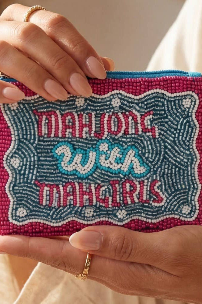 Hand holding a beaded pouch with 'Mahjong with Maggiris' text