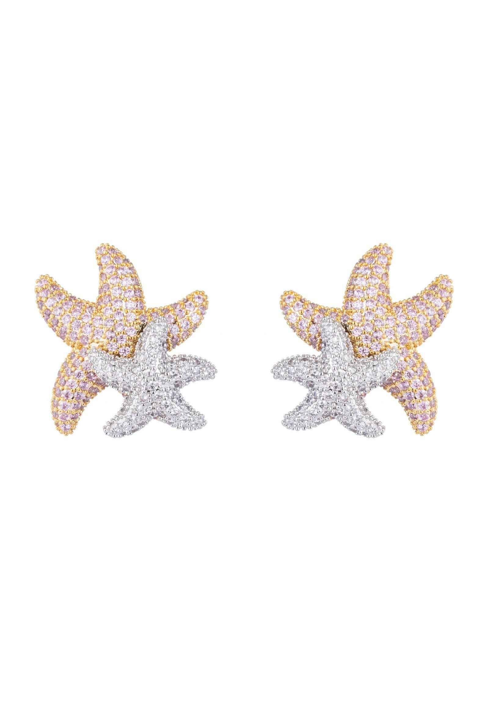 Starfish-shaped earrings with gold and silver detailing on a white background
