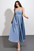 Woman wearing a blue dress against a plain background