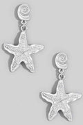 Starfish-shaped earrings on a light gray background