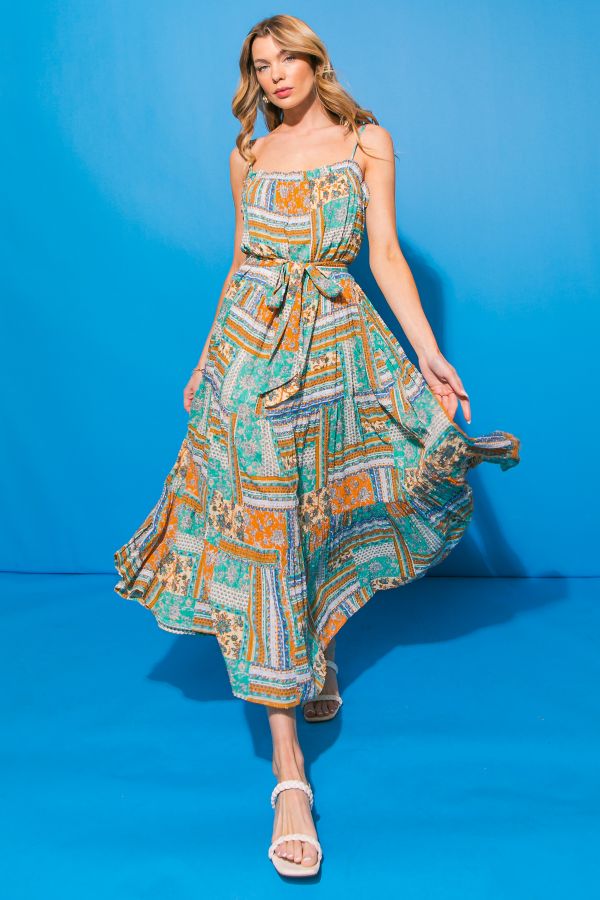 Woman wearing a patterned dress on a blue background