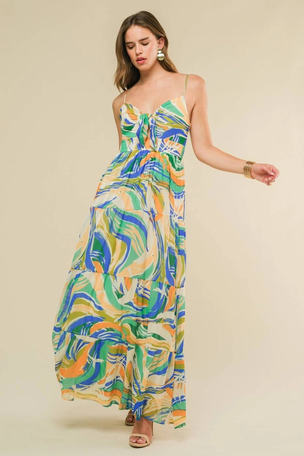 Woman wearing a colorful patterned dress on a beige background
