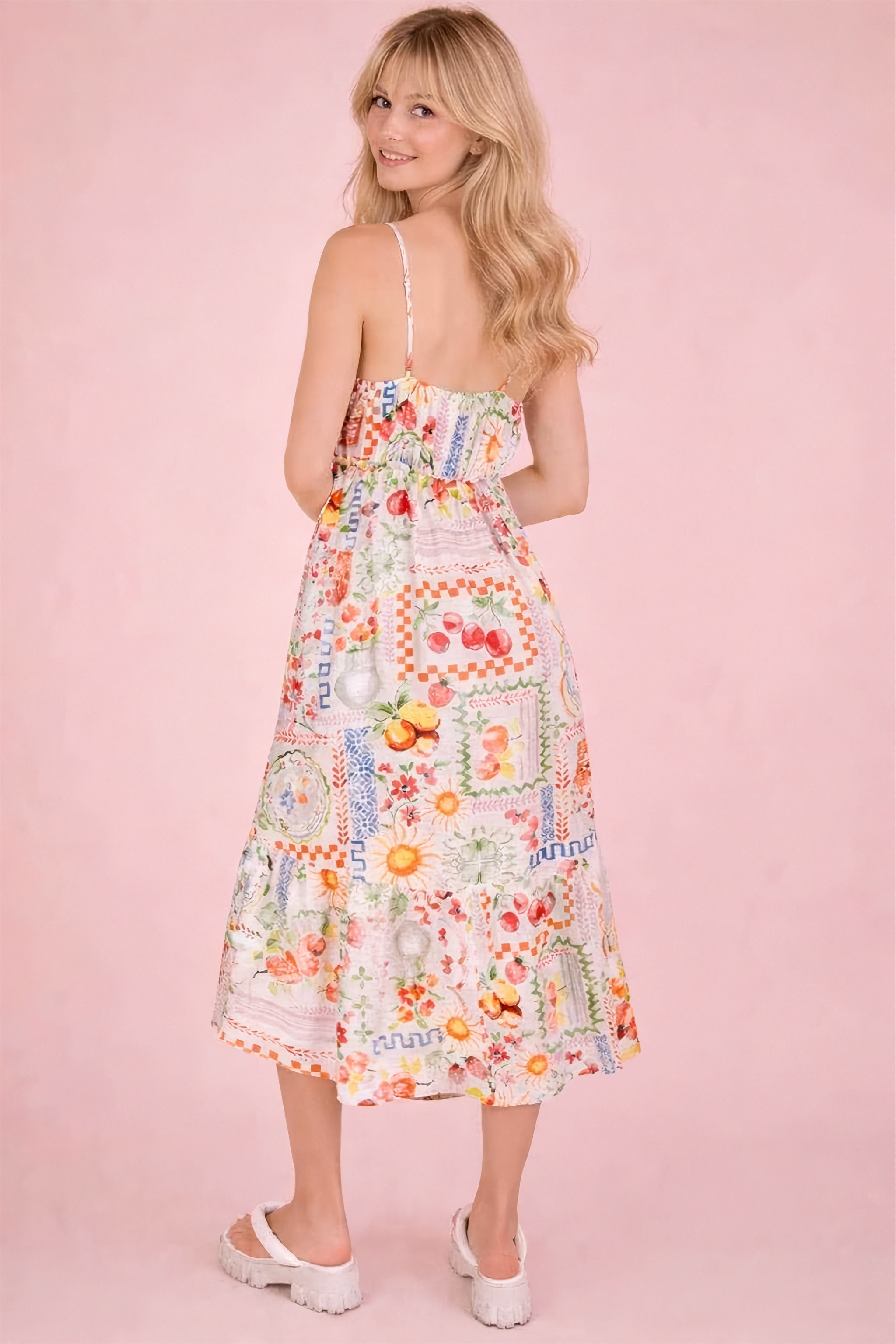Woman wearing a floral dress on a pink background
